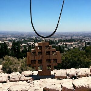 Wooden Jerusalem cross on black cord.